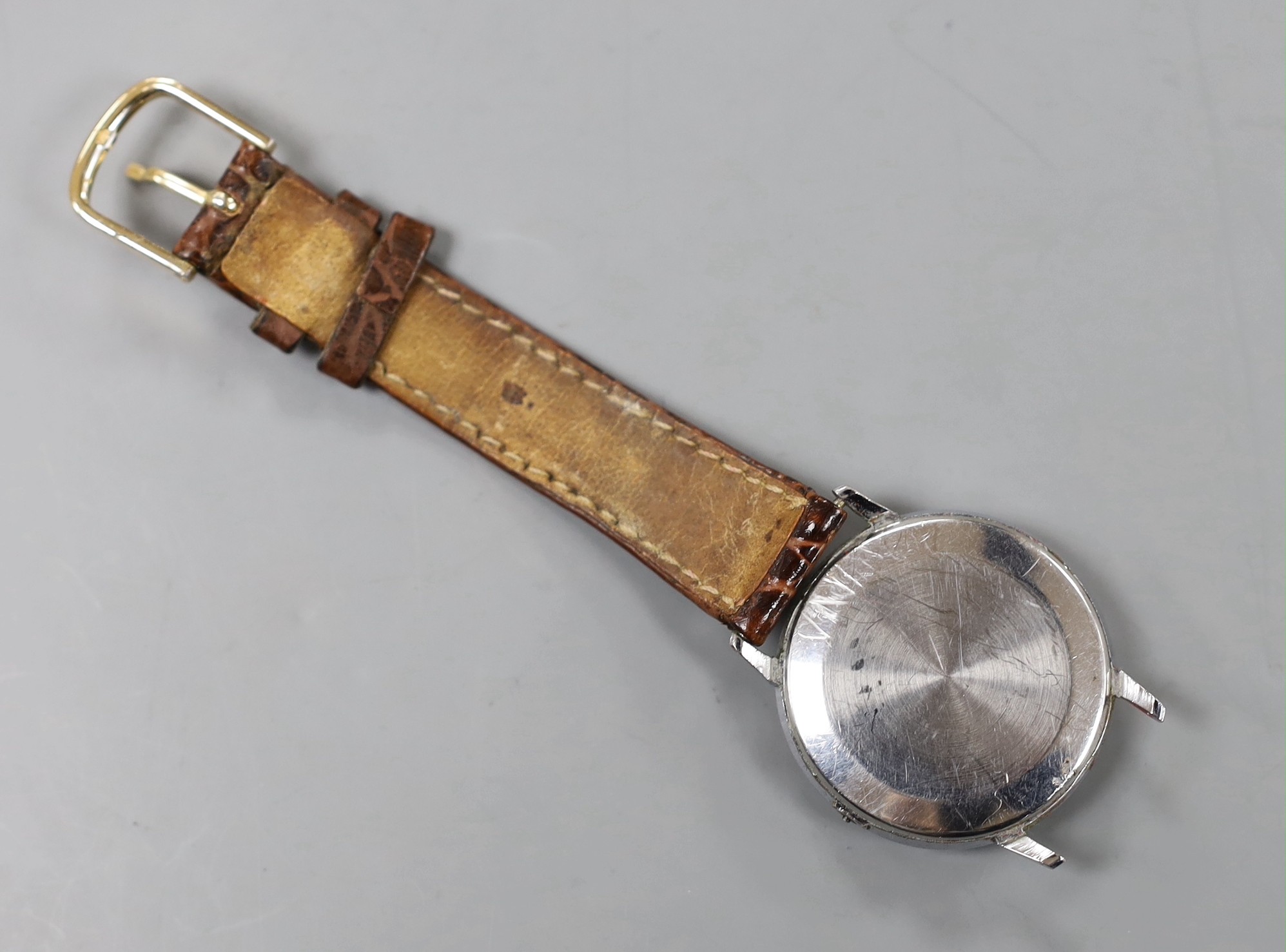 A gentleman's stainless steel Omega manual wind wrist watch, (numeral loose and part of strap missing).
